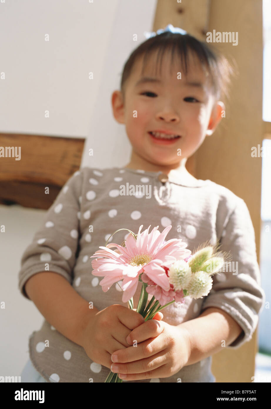 Girl holding flowers Stock Photo