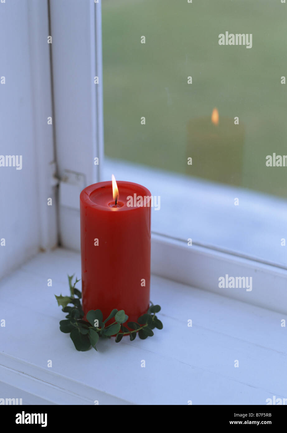 Red candle on windowsill Stock Photo Alamy