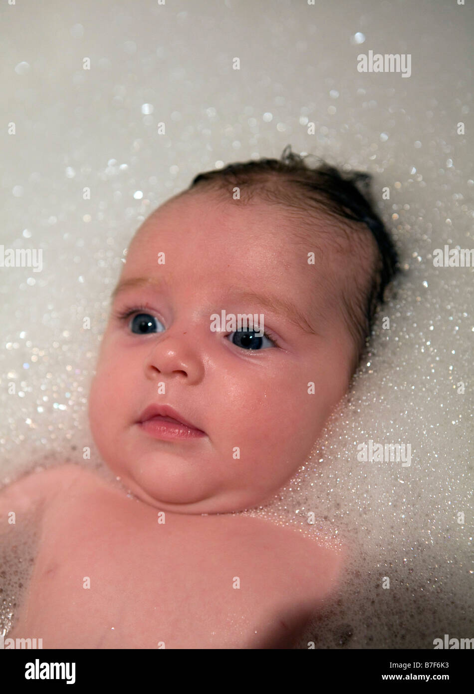 Baby in a bath full of bubbles Stock Photo Alamy