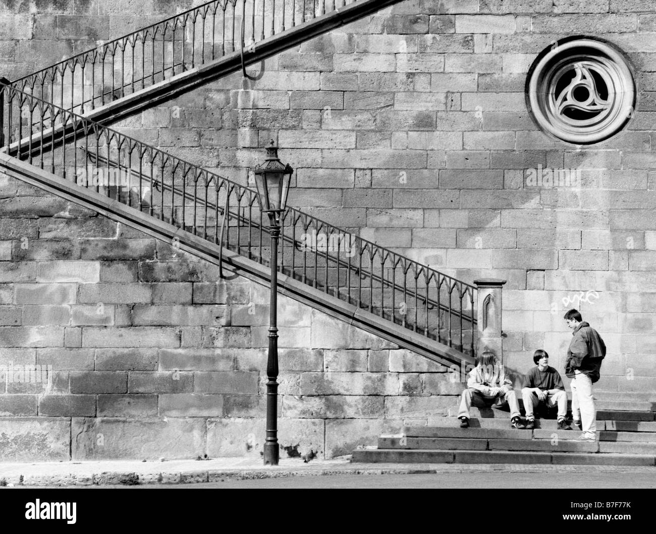 Prague, Czech Republic. Boys by staircase from Kampa Island to Charles Bridge Stock Photo