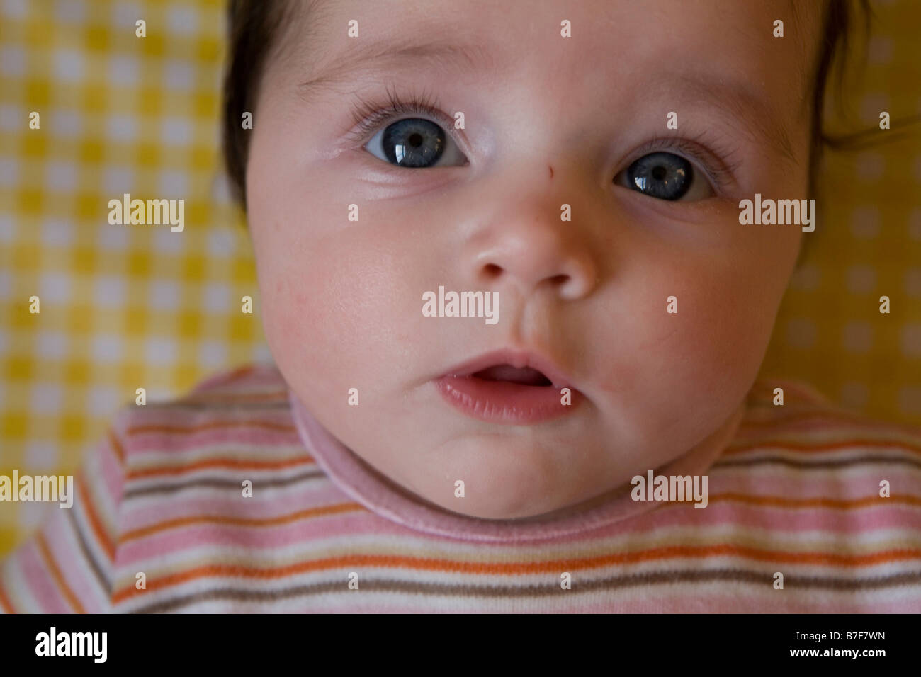 A baby girl with bright eyes Stock Photo