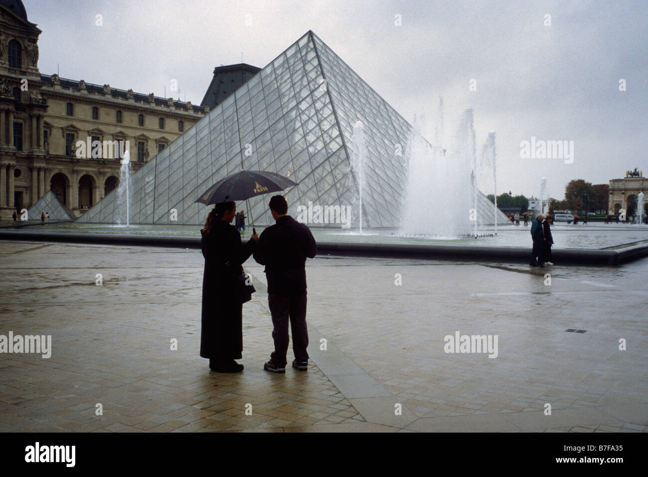 Paris France Tourists sightseeing on a rainy day the Louvre Paris Stock ...