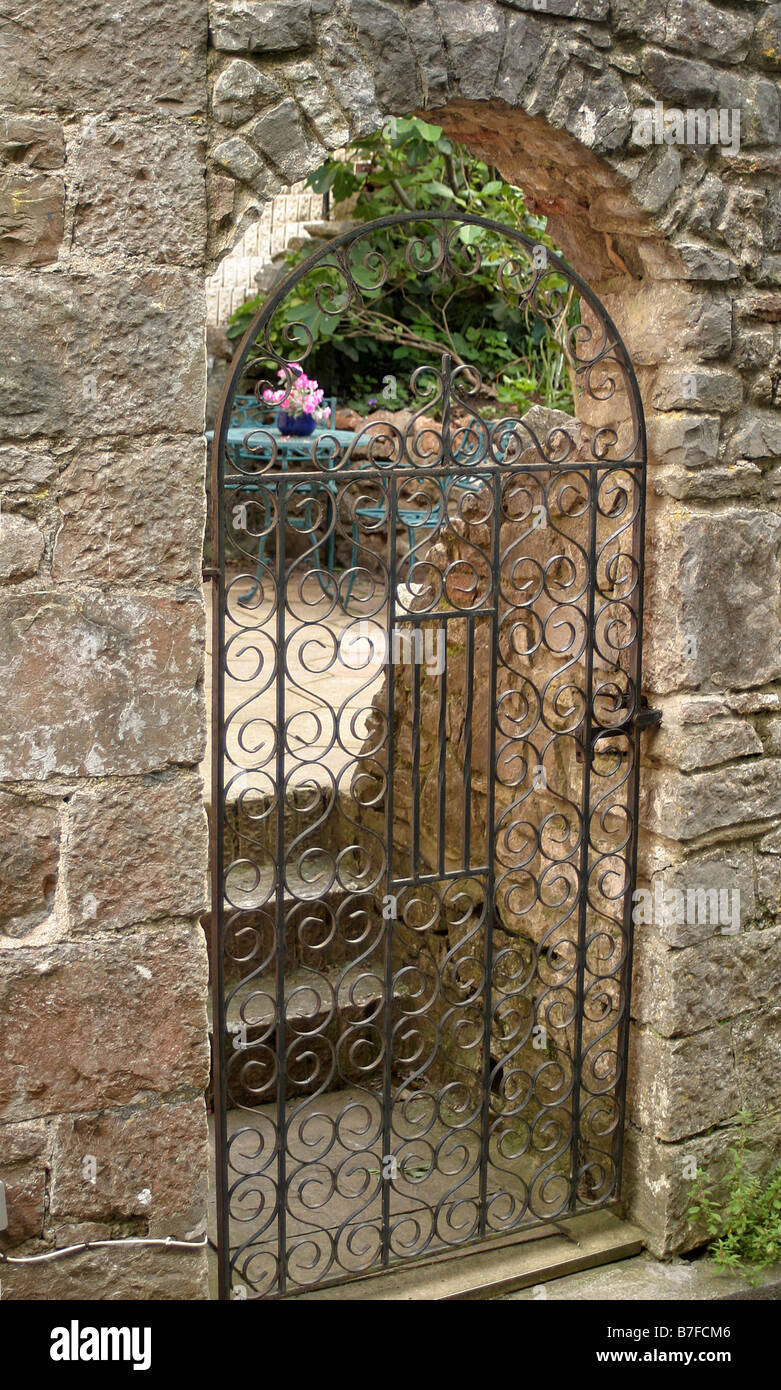 Iron gate to a secret garden Stock Photo - Alamy