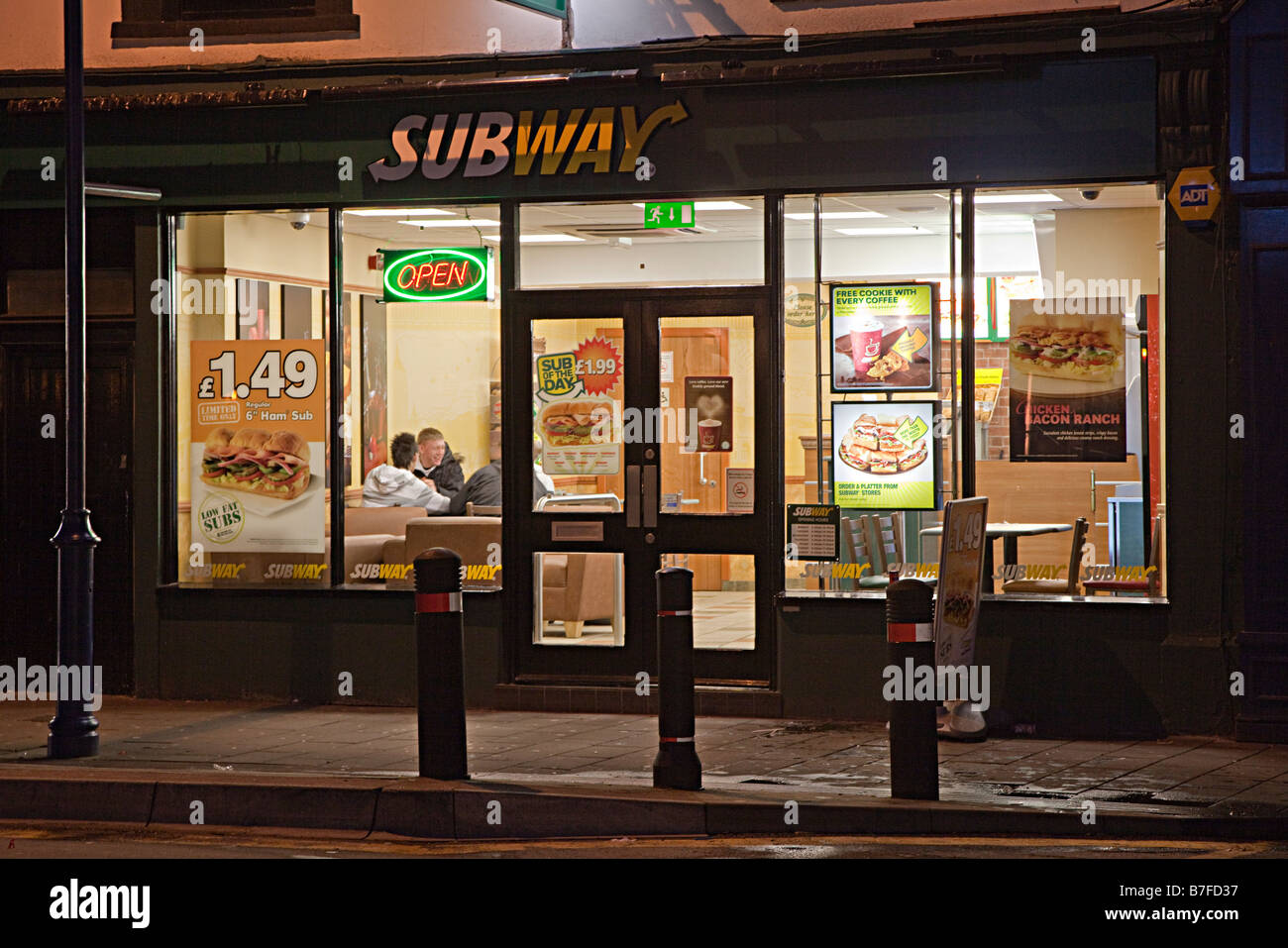 Youths in Subway fast food cafe at night Abergavenny Wales UK Stock Photo