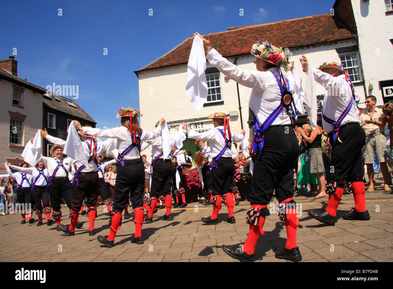 Morris men dancing in the street with handkerchiefs outside the Rose & Crown pub at Warwick Folk Festival, Warwick, UK Stock Photo