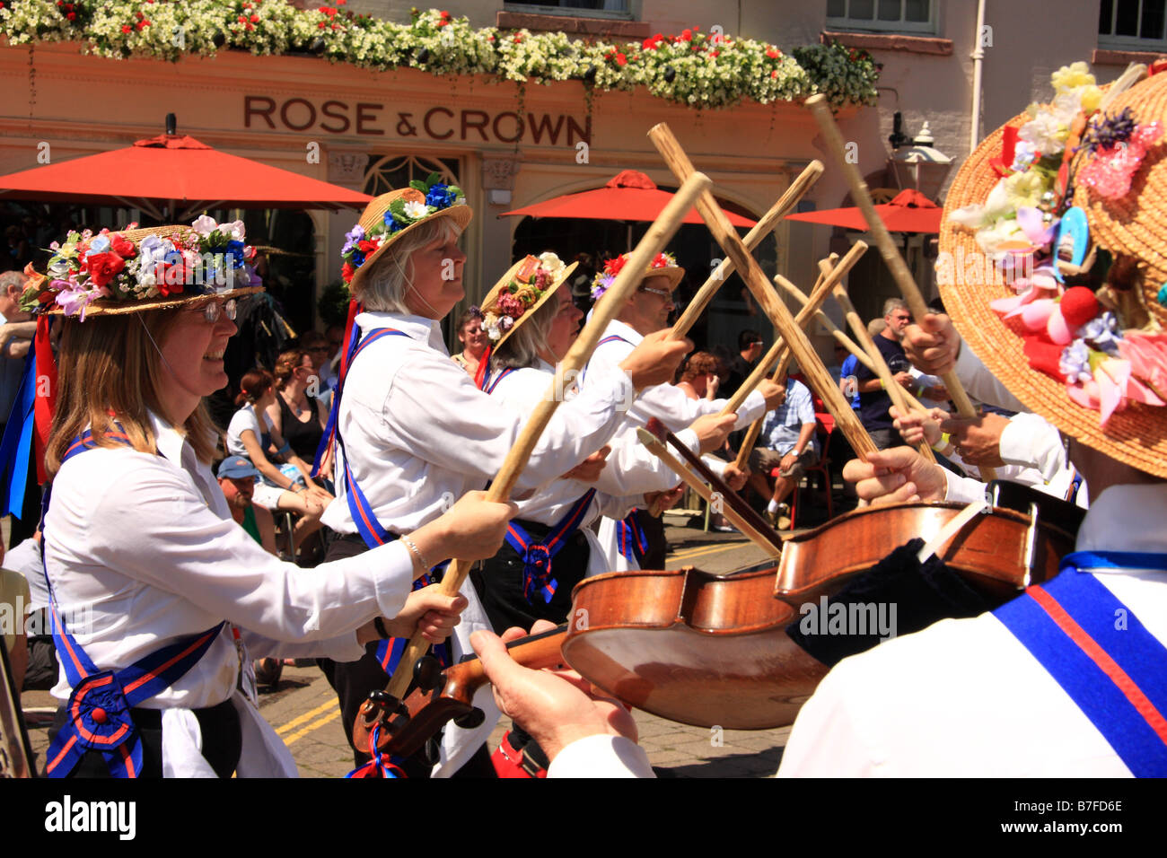 Morris dancers perform with sticks outside the Rose & Crown Pubic House at Warwick Folk Festival, Warwick, UK Stock Photo