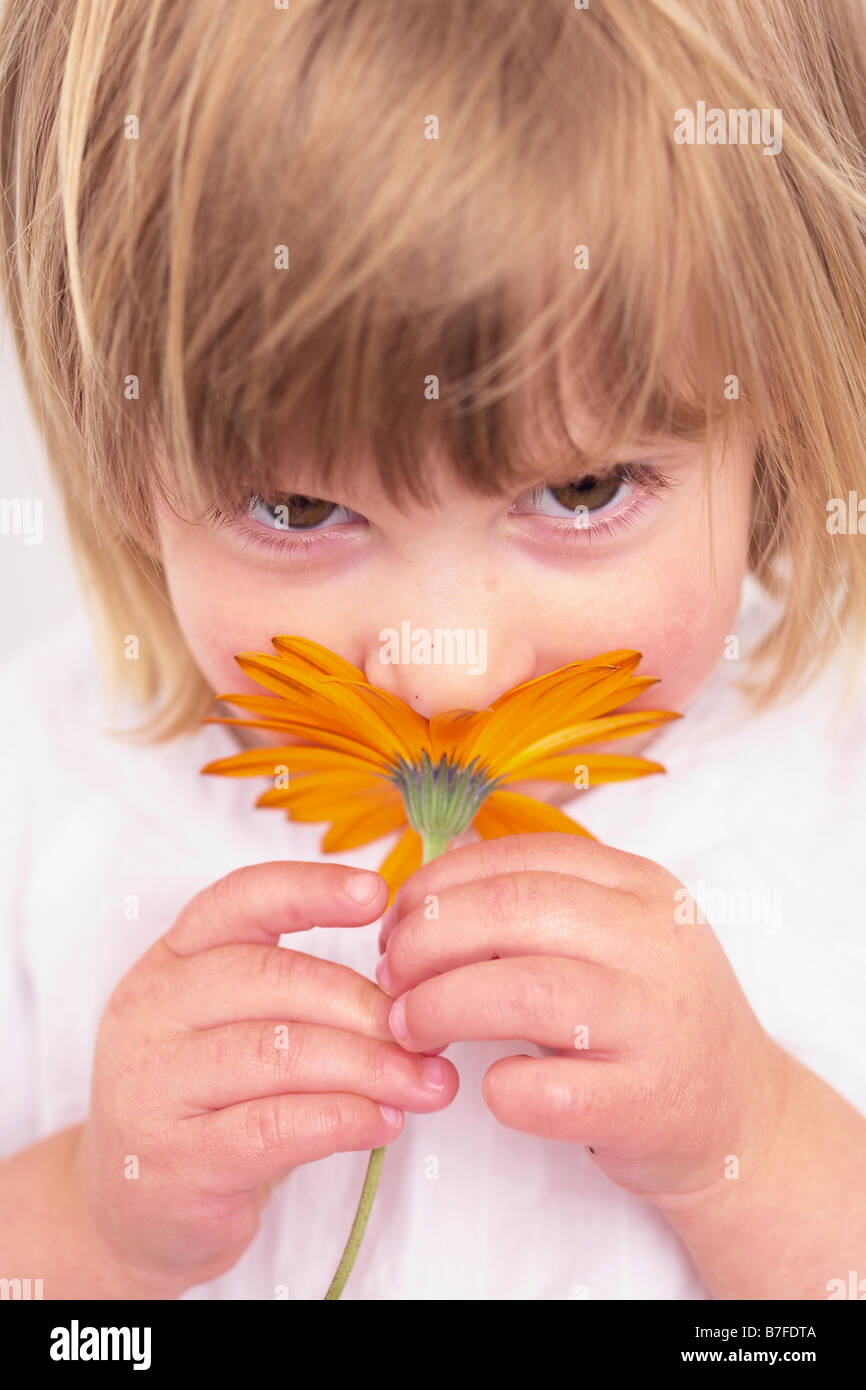 girl smelling flower Stock Photo Alamy