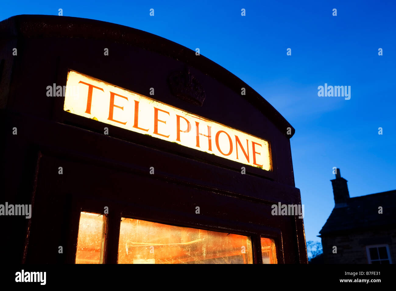 Lit K6 red telephone box in an English village Stock Photo - Alamy