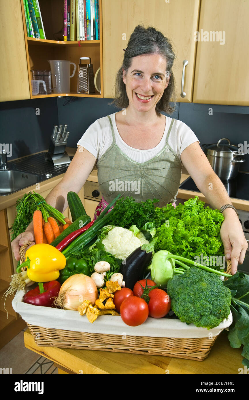 woman with basket of vegetables Stock Photo