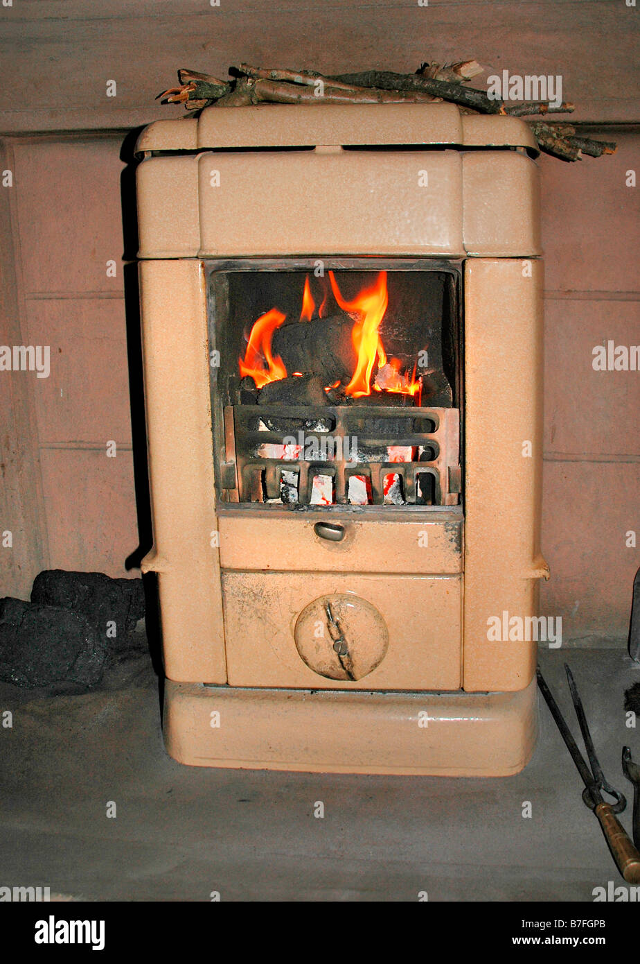 An old fashioned fireplace with kindling wood on top to dry. Stock Photo