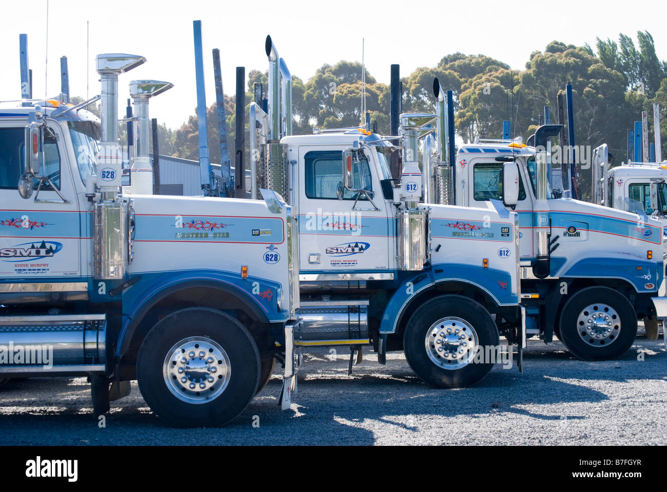 Modern fleet of Log & Bulk transport trucks, Main North Road, Kaiapoi, Canterbury, New Zealand Stock Photo