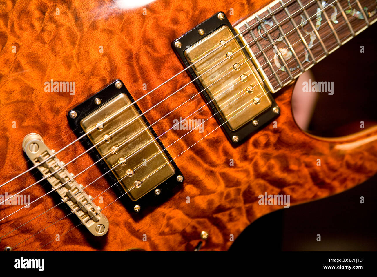 Electronic pickups on electric guitar carry sound to amplifier Stock