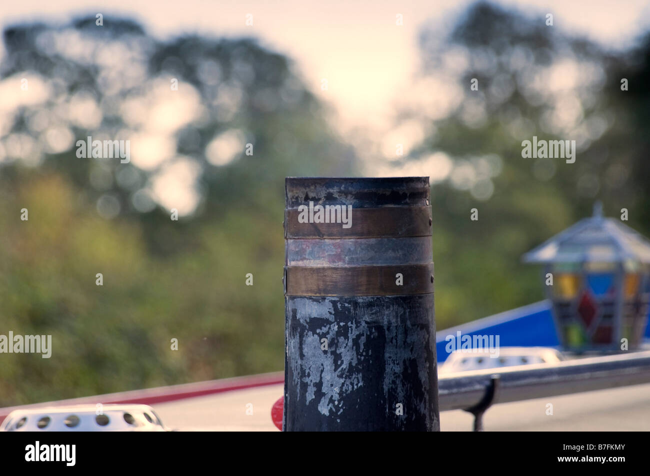 A chimney on a narrow boat with smoke coming from it Stock Photo - Alamy