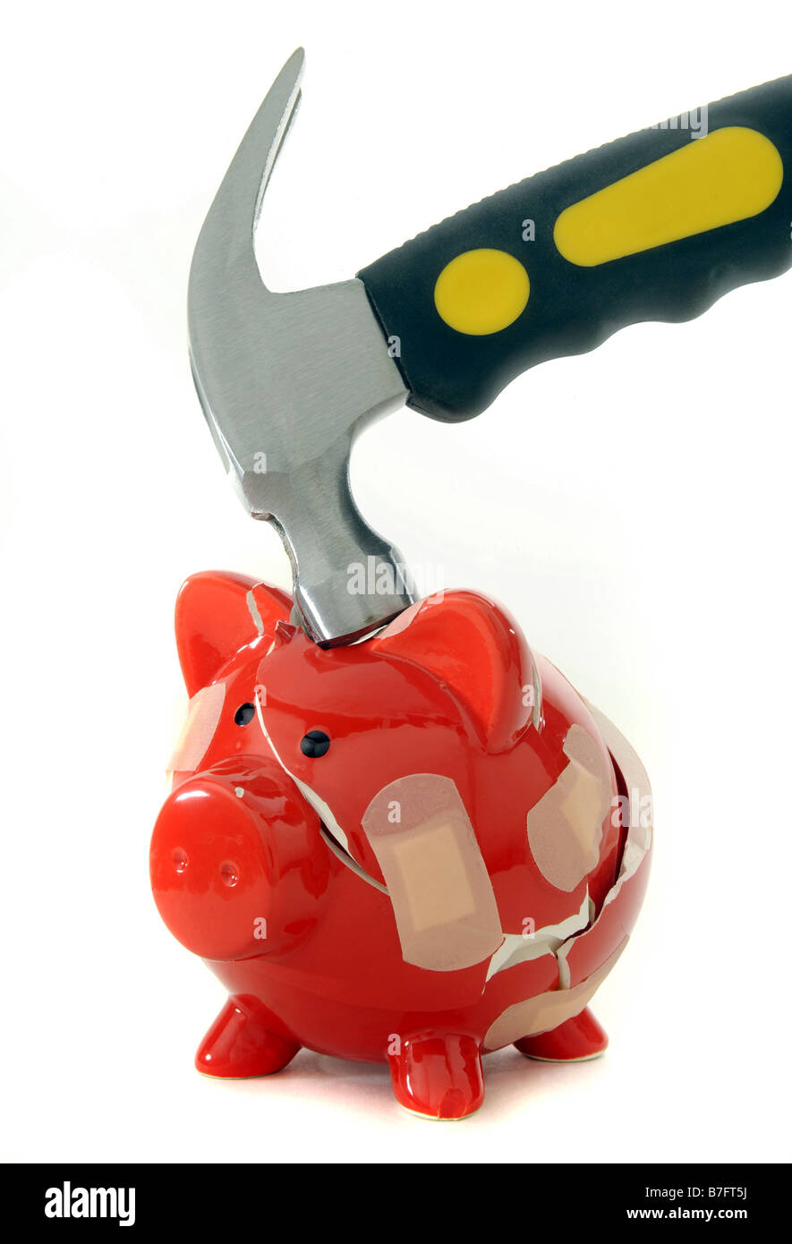 RED  PIGGYBANK BROKEN BY A HAMMER HELD TOGETHER WITH PLASTERS. Stock Photo