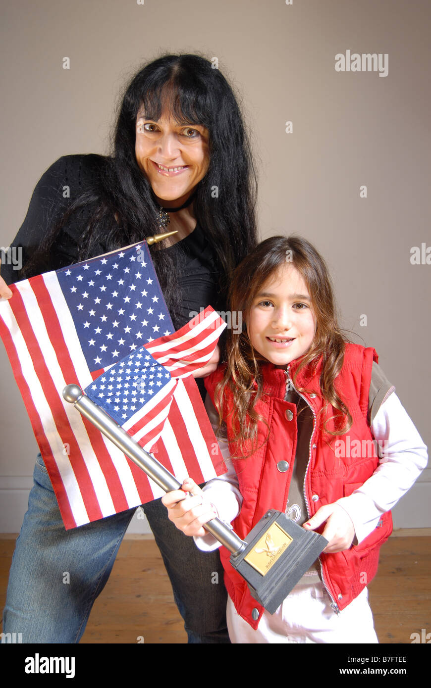 A Patriotic and Eccentric Woman and Boy standing with American Flags Stock Photo
