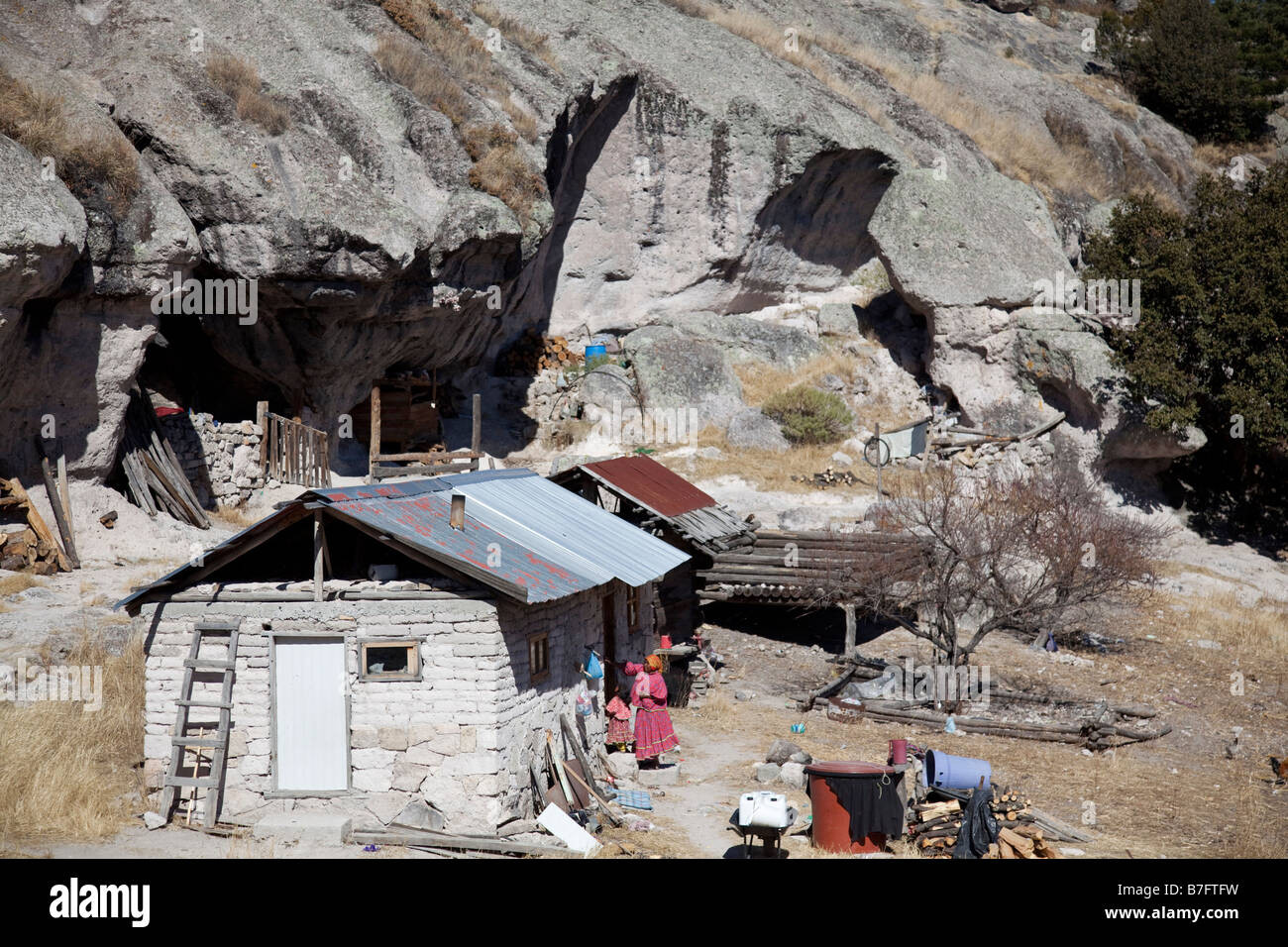 Young girl sits by her simple adobe and log home in the Tarahumara village  of San Alonso in the Copper Canyon area of Mexico Stock Photo - Alamy