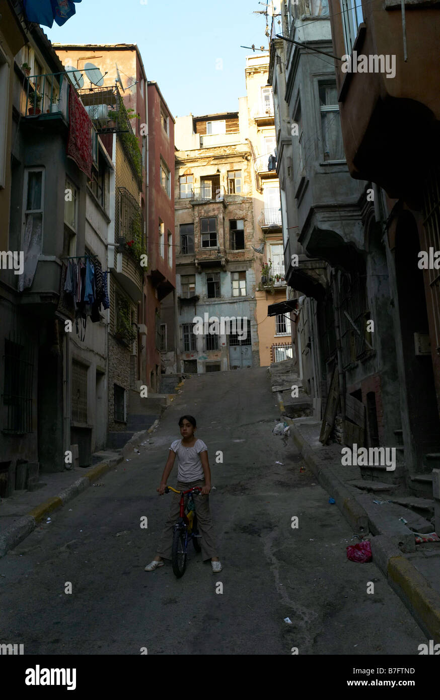 A young girl cycling down a street in Istanbul Turkey Stock Photo