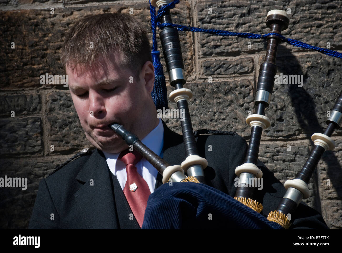 Bagpipe player against wall , Edinburgh , Scotland Stock Photo Alamy