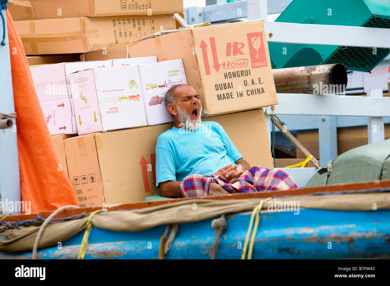worker feeling shattered in the dock of Dubai UAE Stock Photo