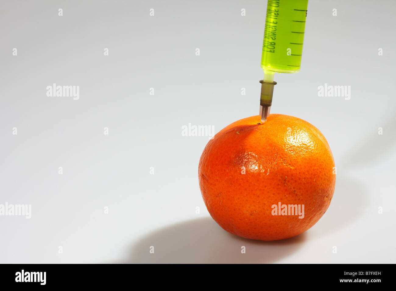 Hypodermic Syringe and Orange Stock Photo