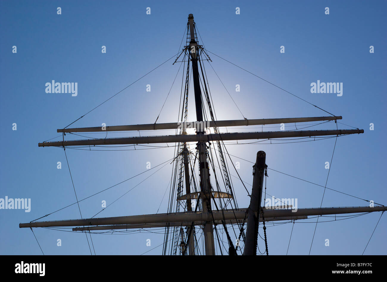 Silhouette of Sailing Mast against a blue sky Stock Photo