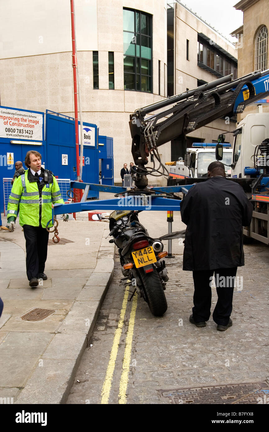police remove an illegally parked motorcycle in London Stock Photo