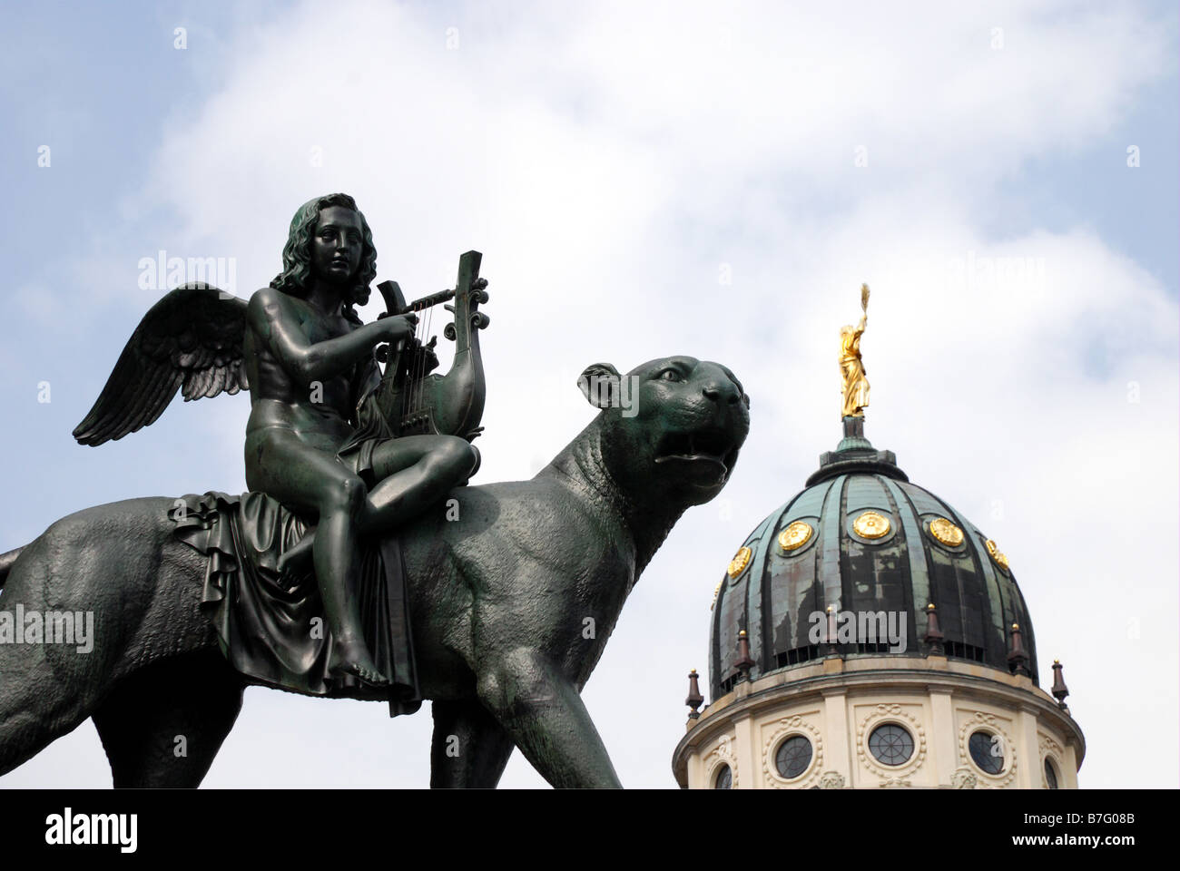 Statue outside Berlin Concert Hall with French Cathedral in the background Stock Photo