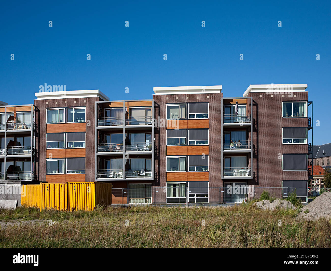 Modern block of flats with people on balcony of one Harlingen Friesland Netherlands Stock Photo
