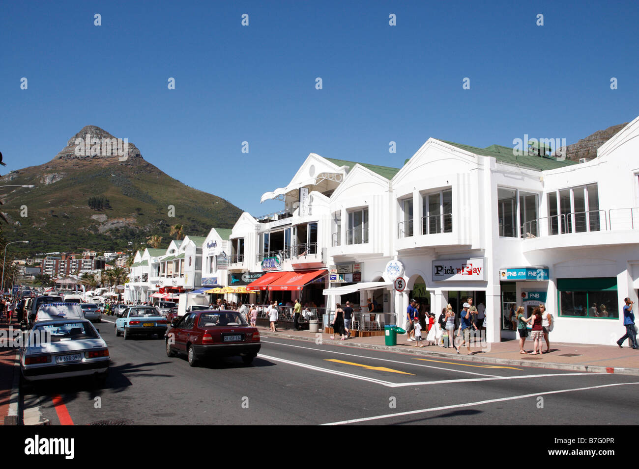 view along victoria road the main route along the beach front lions head is to the left camps bay cape town south africa Stock Photo