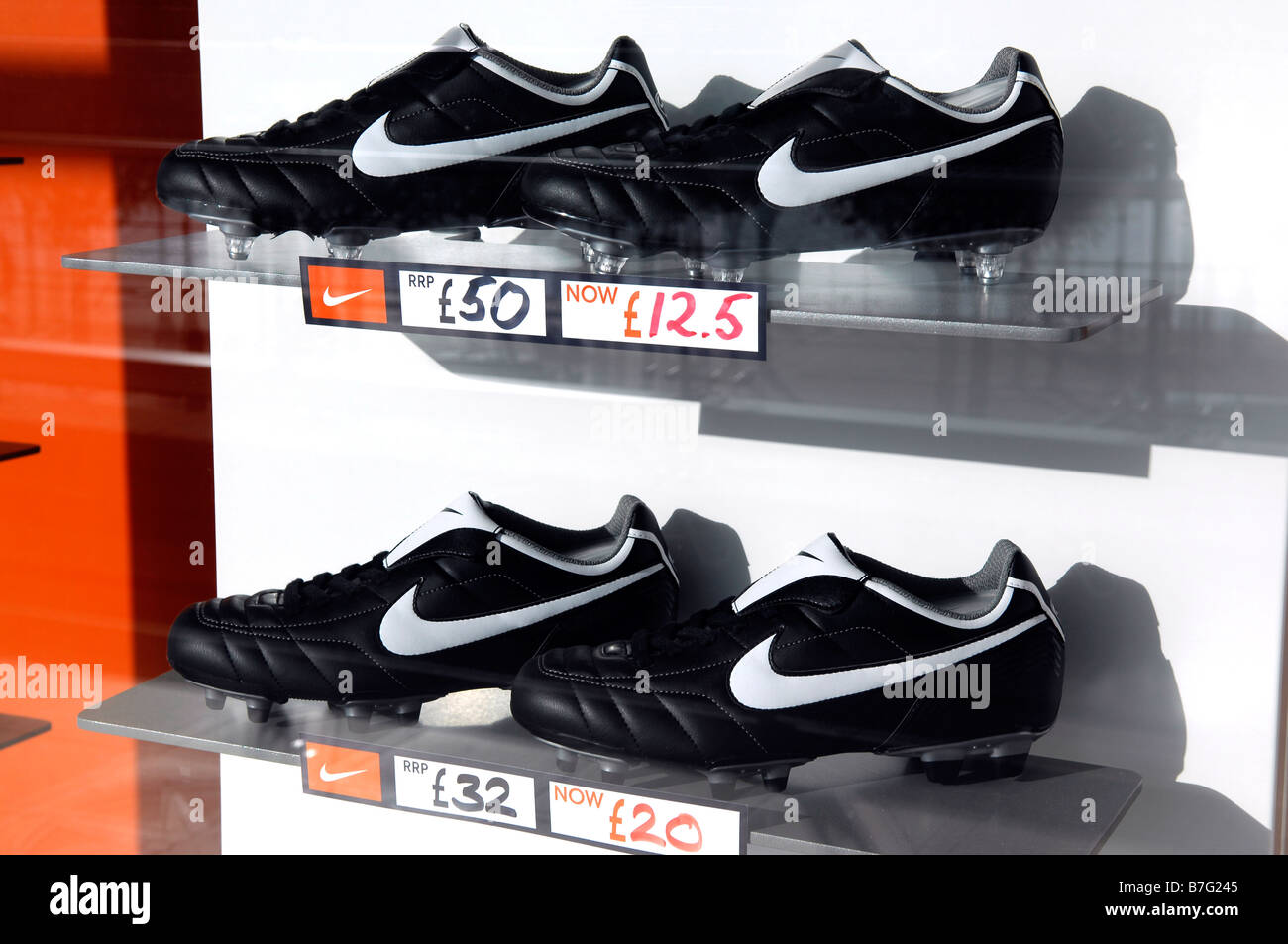 nike footwear football boots soccer shoes window display reduced american company fashion retail shop store niketown Stock Photo