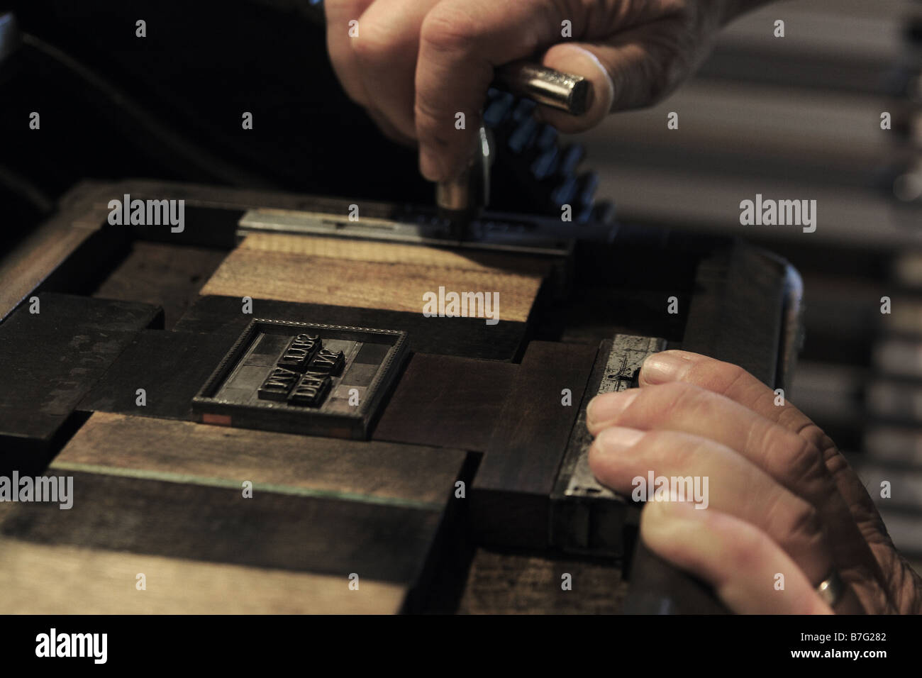 a printer adjusts the pressure on a type chase for letterpress Stock Photo