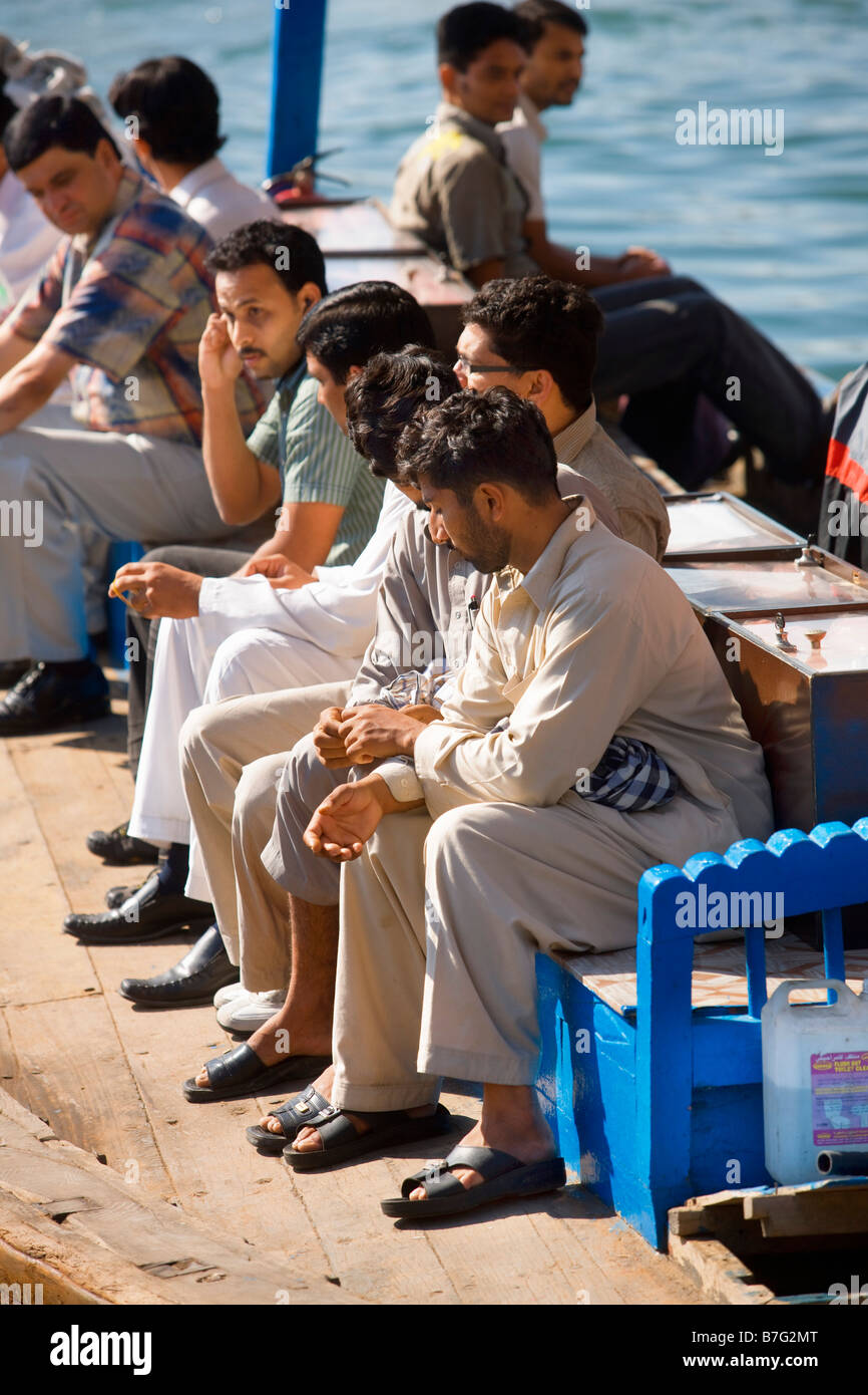 men sitting on an abra at Dubai Stock Photo