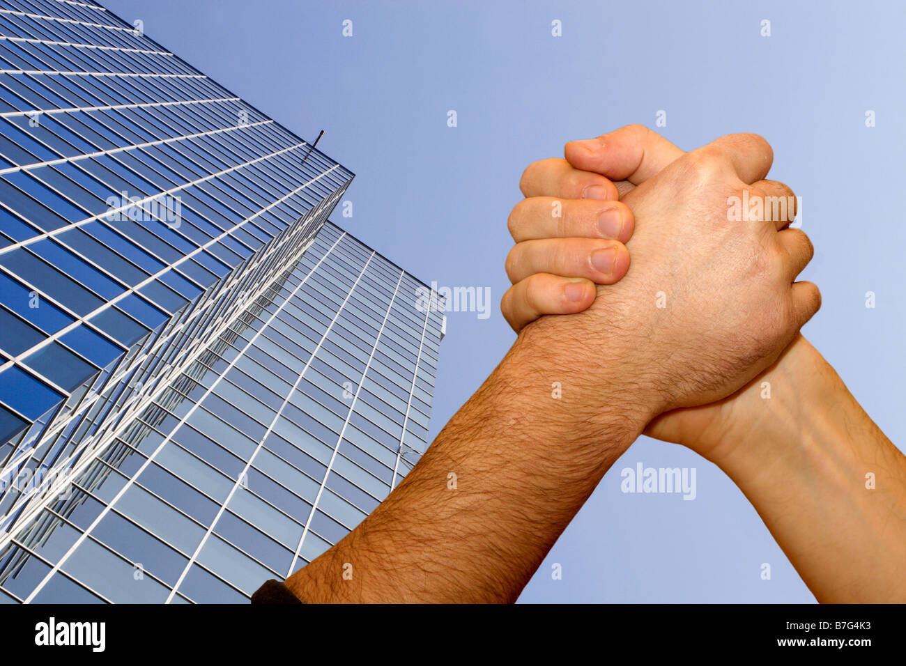 hands of men by emulation and skyscraper Stock Photo