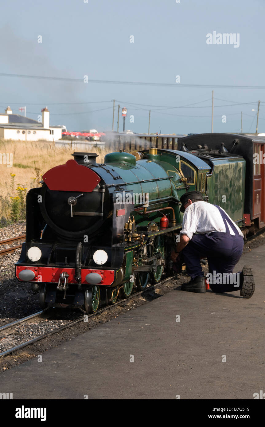 A man working on a miniature steam train Stock Photo