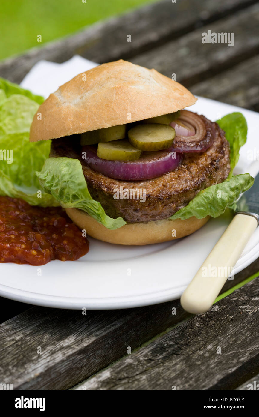 Beef burger in a bun with salad relish onion gerkin gherkin Stock Photo