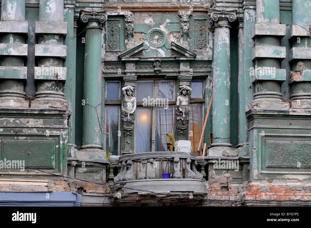 Dilapidated facade  and balcony of an old majestic building in central Odessa, Ukraine. Stock Photo