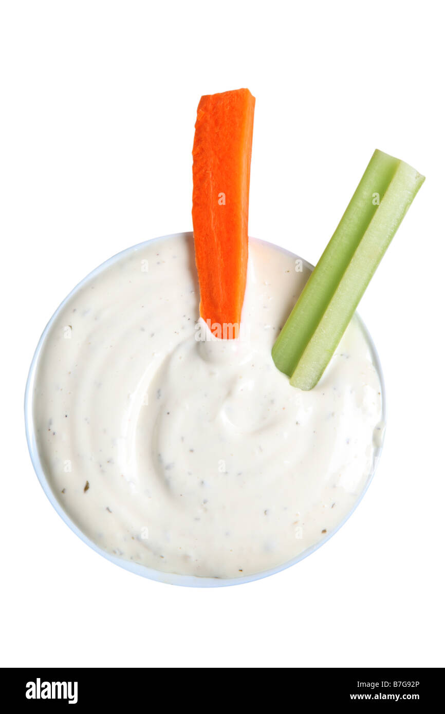 Celery and Carrot sticks in bowl of dip cut out on white background Stock Photo