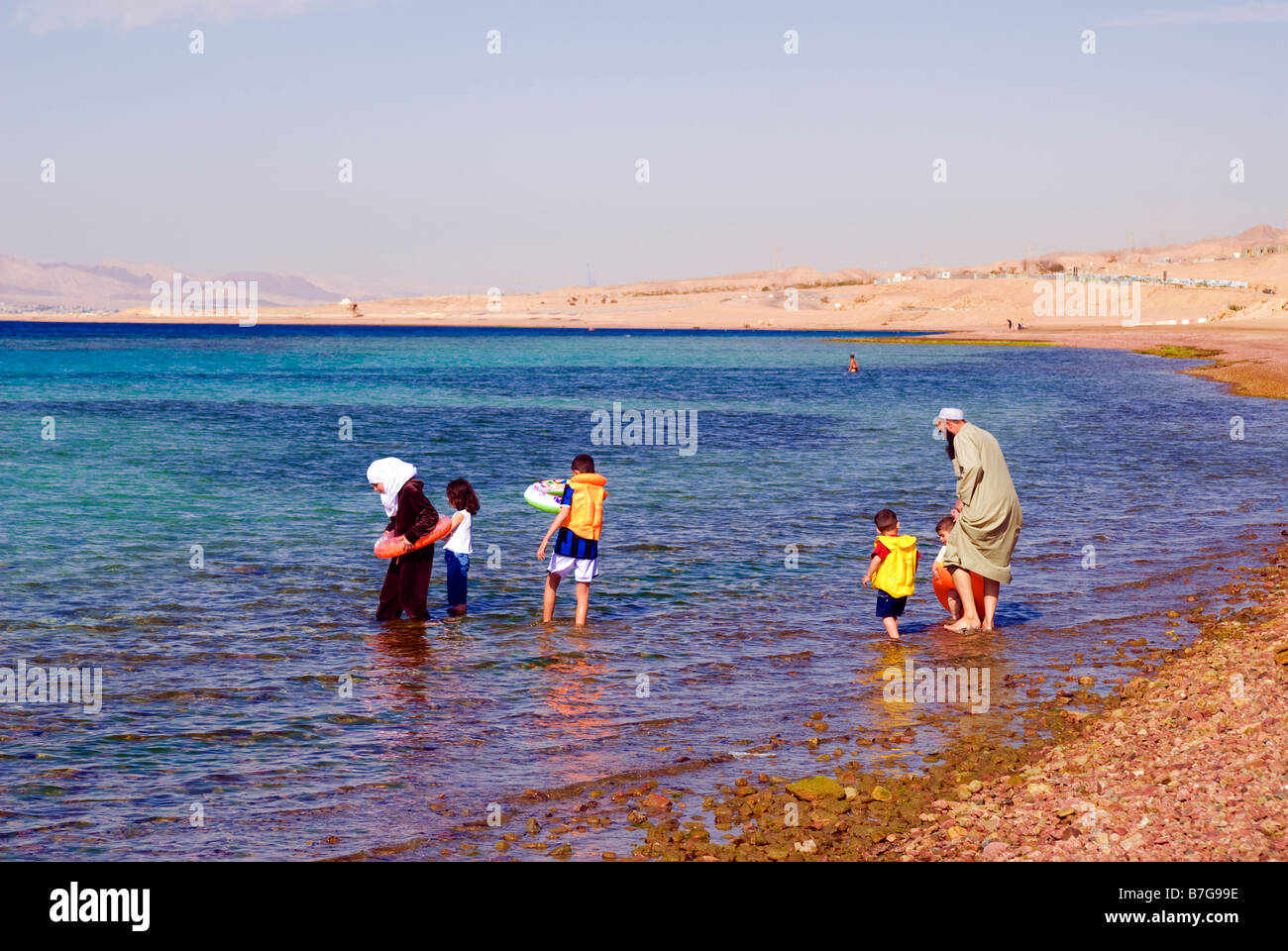 Muslim family taking a bath in Red Sea Aqaba Jordan Stock Photo - Alamy