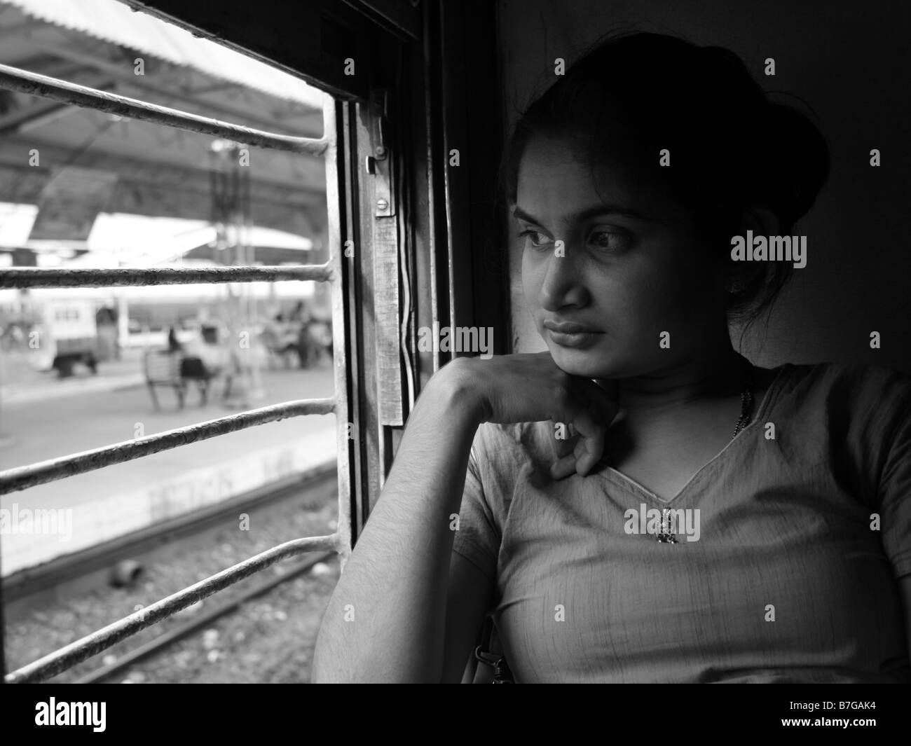 Beautiful woman looking from a train window in India Stock Photo