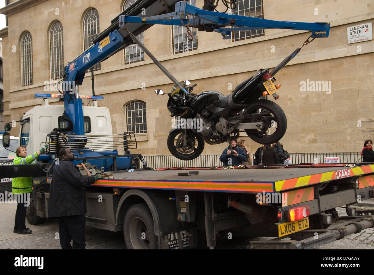 police remove an illegally parked motorcycle in London Stock Photo