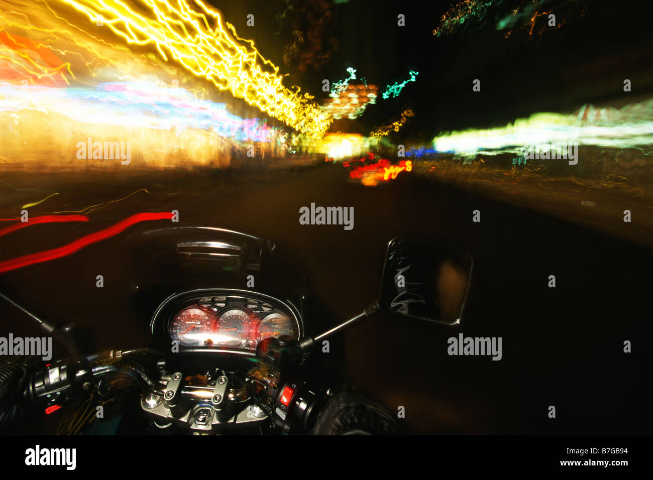 Queensland Australia A motorbike on a city street at night Photo Simon Grosset Stock Photo