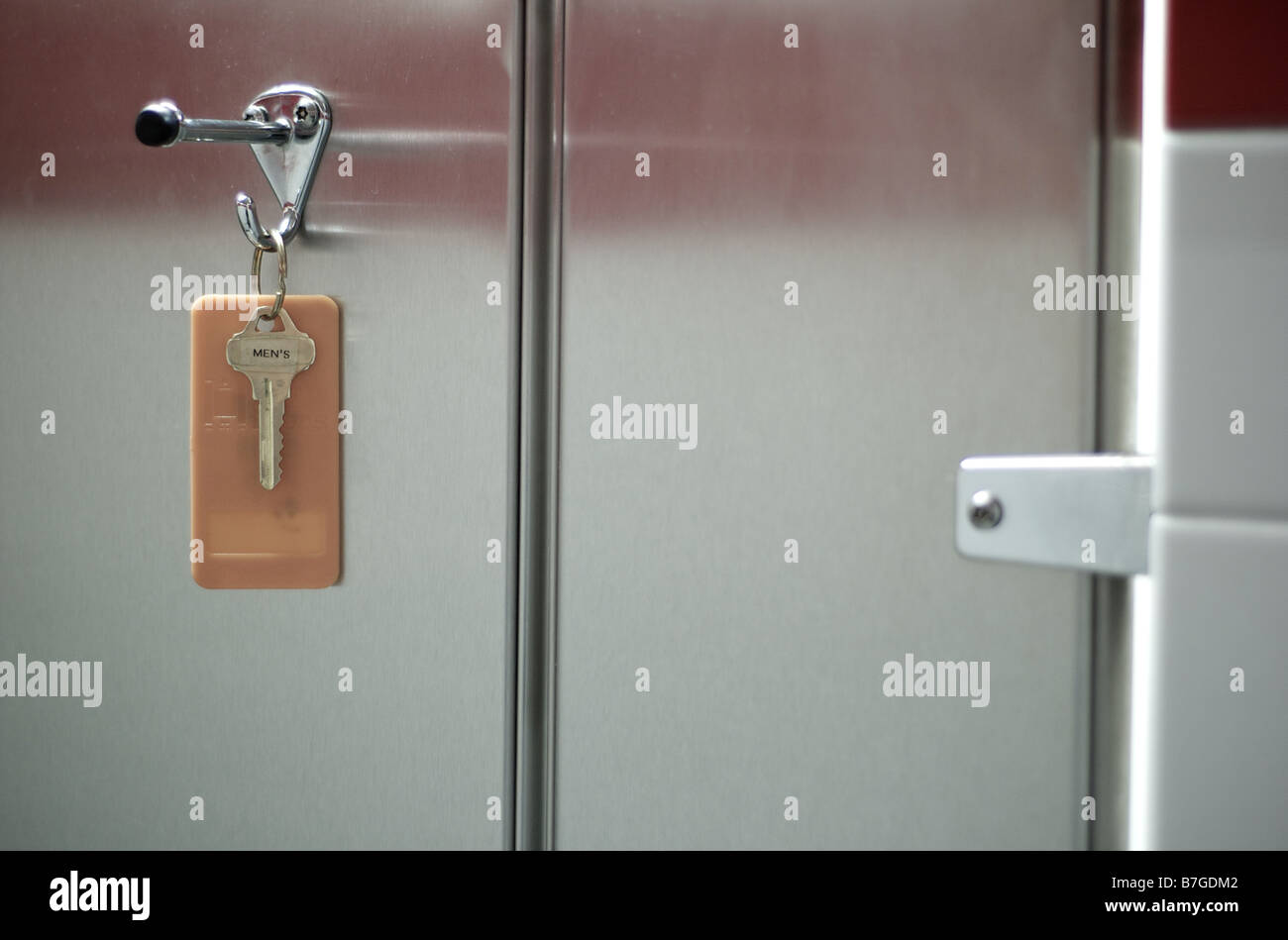 Mens Restroom Key Hanging on Coat Hook Stock Photo