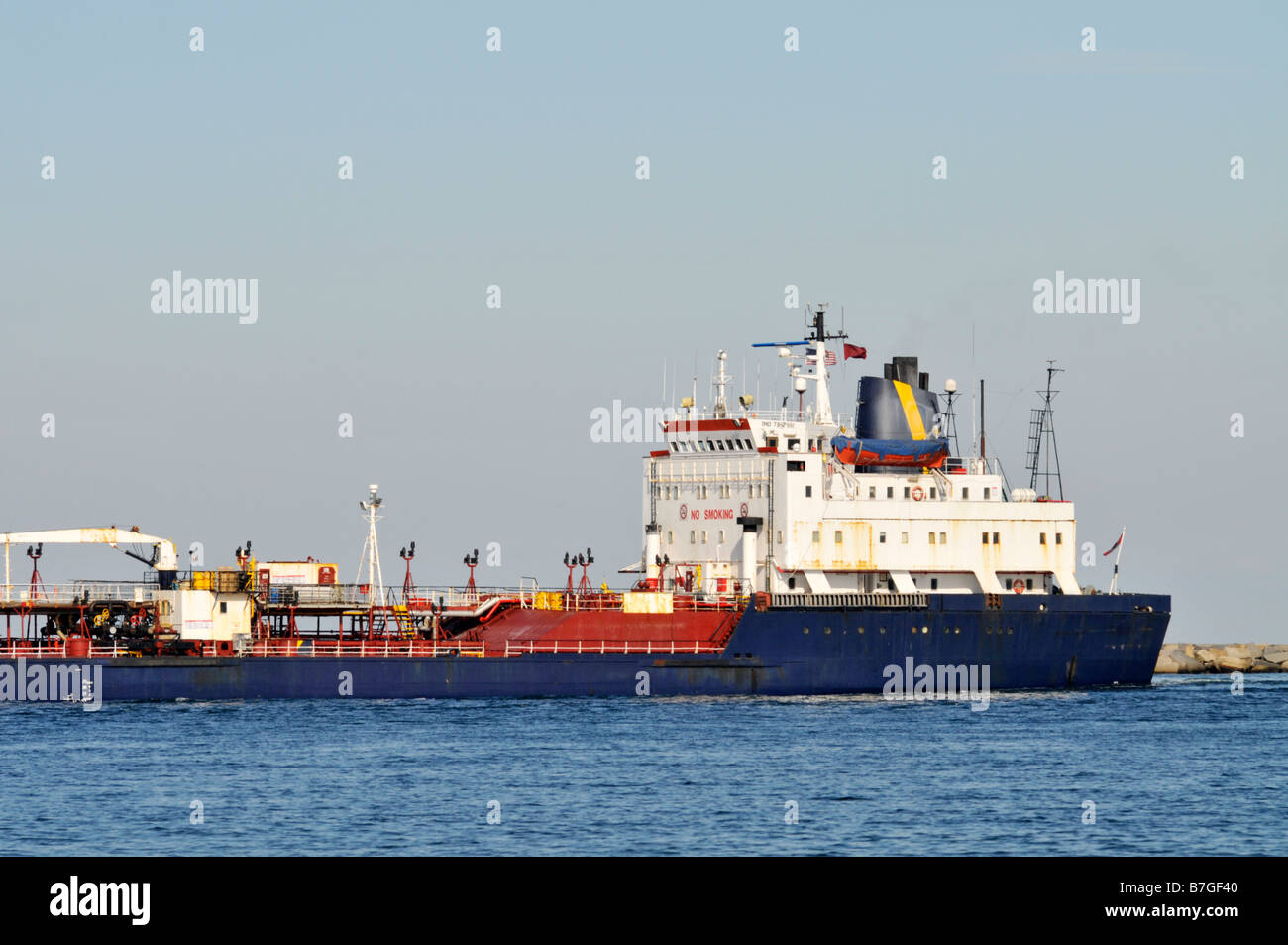 Profile view of an oil tanker superstructure and deck with blue hull at