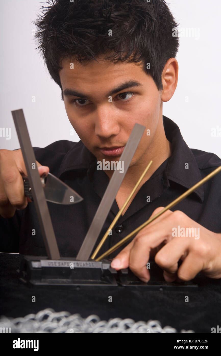 A young Asian American man sharpening his knife Stock Photo Alamy