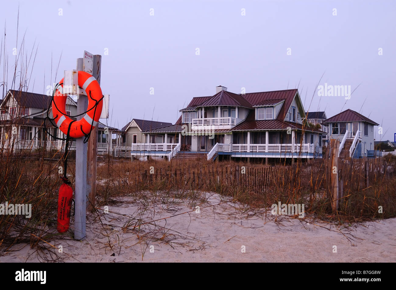 A lifeguard buoy, sand dunes, and beach house just before sunrise on Bald Head Island, North Carolina, USA Stock Photo