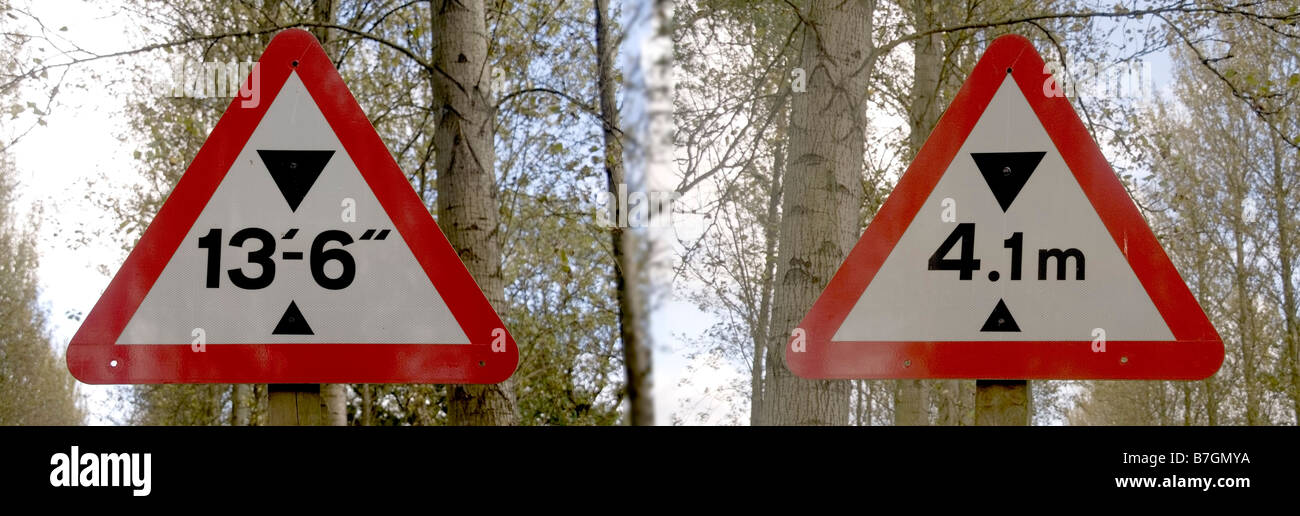 Two road signs indicating the same bridge height in both imperial and