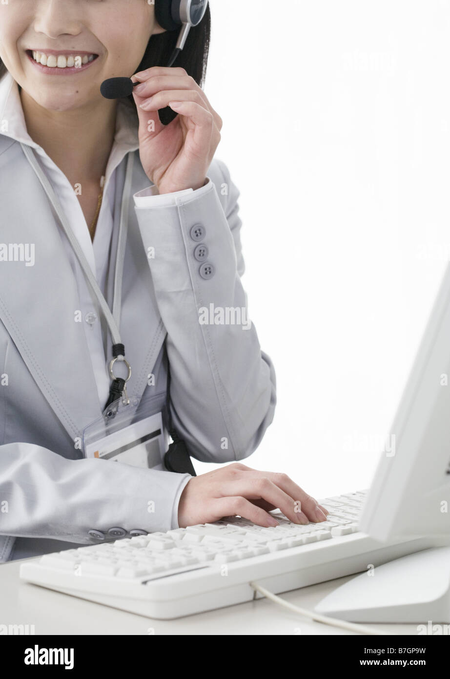 Businesswoman wearing a headphone in the office Stock Photo - Alamy
