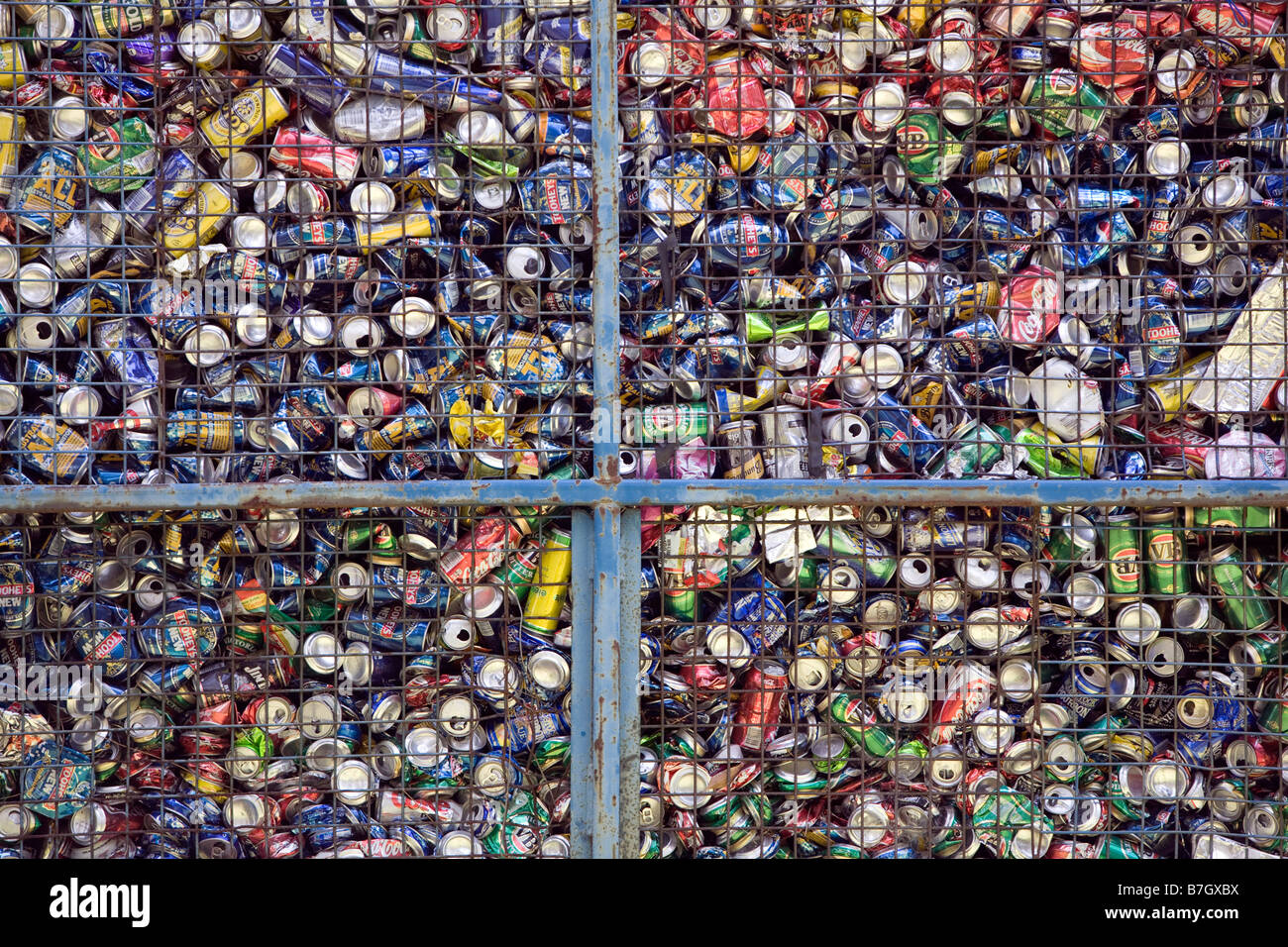 hundreds of metal drinks cans in a mesh container Stock Photo Alamy