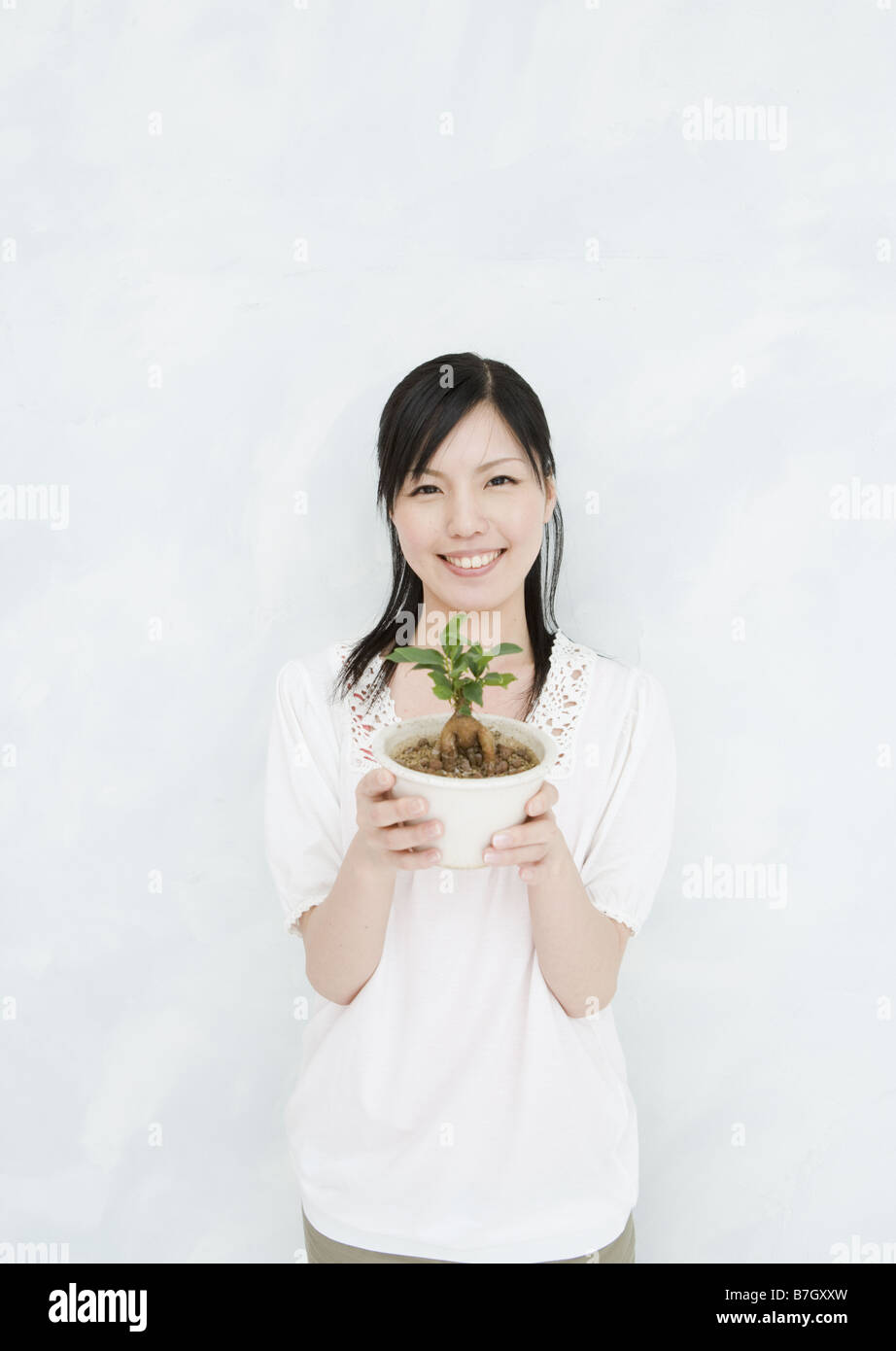 Woman Holding Potted Plant Stock Photo - Alamy