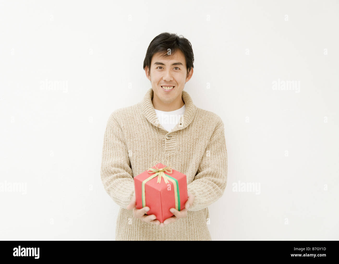 Guy Offering Man Offering Present Stock Photo - Alamy